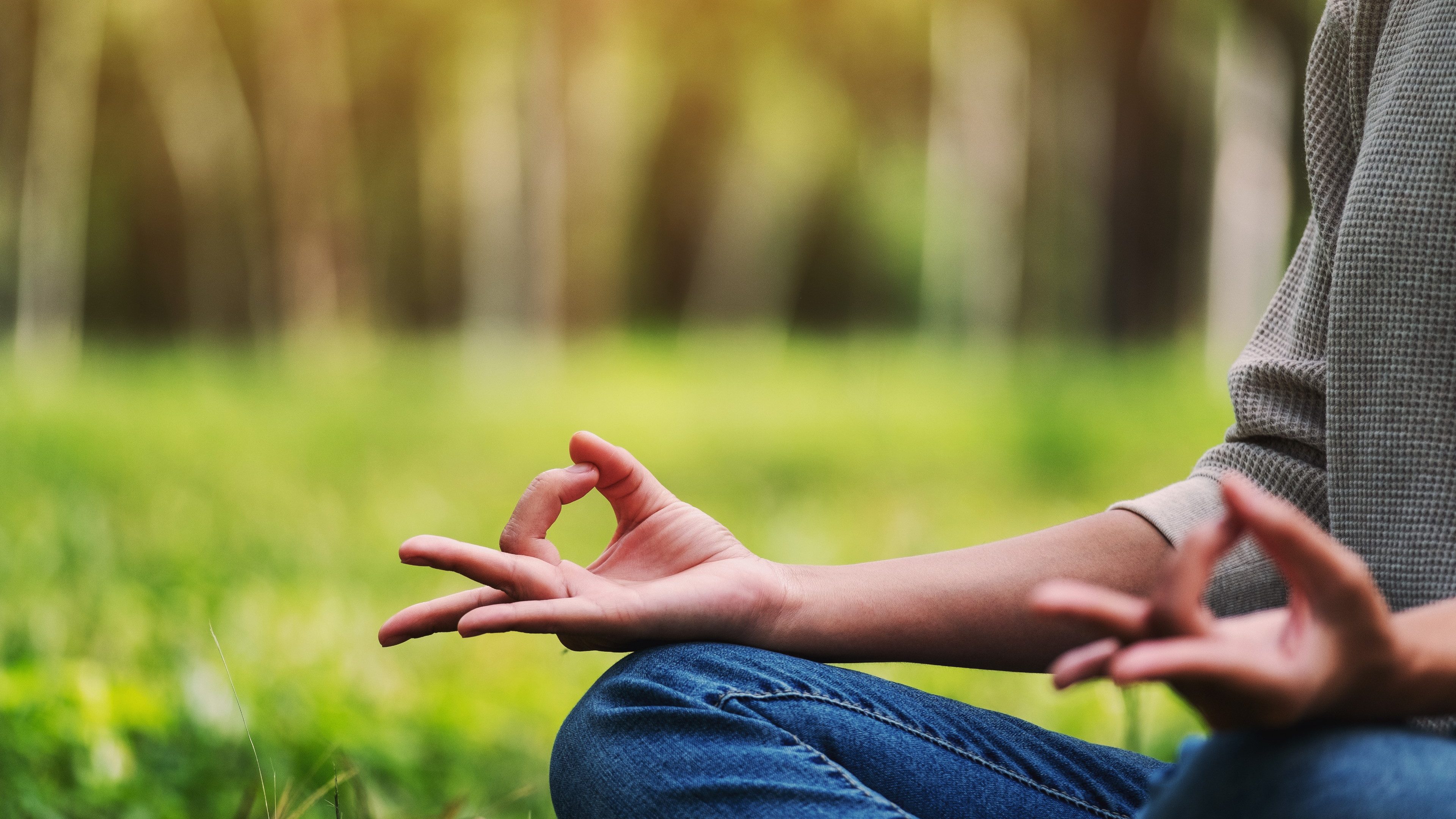 Closeup image of a woman meditating in nature