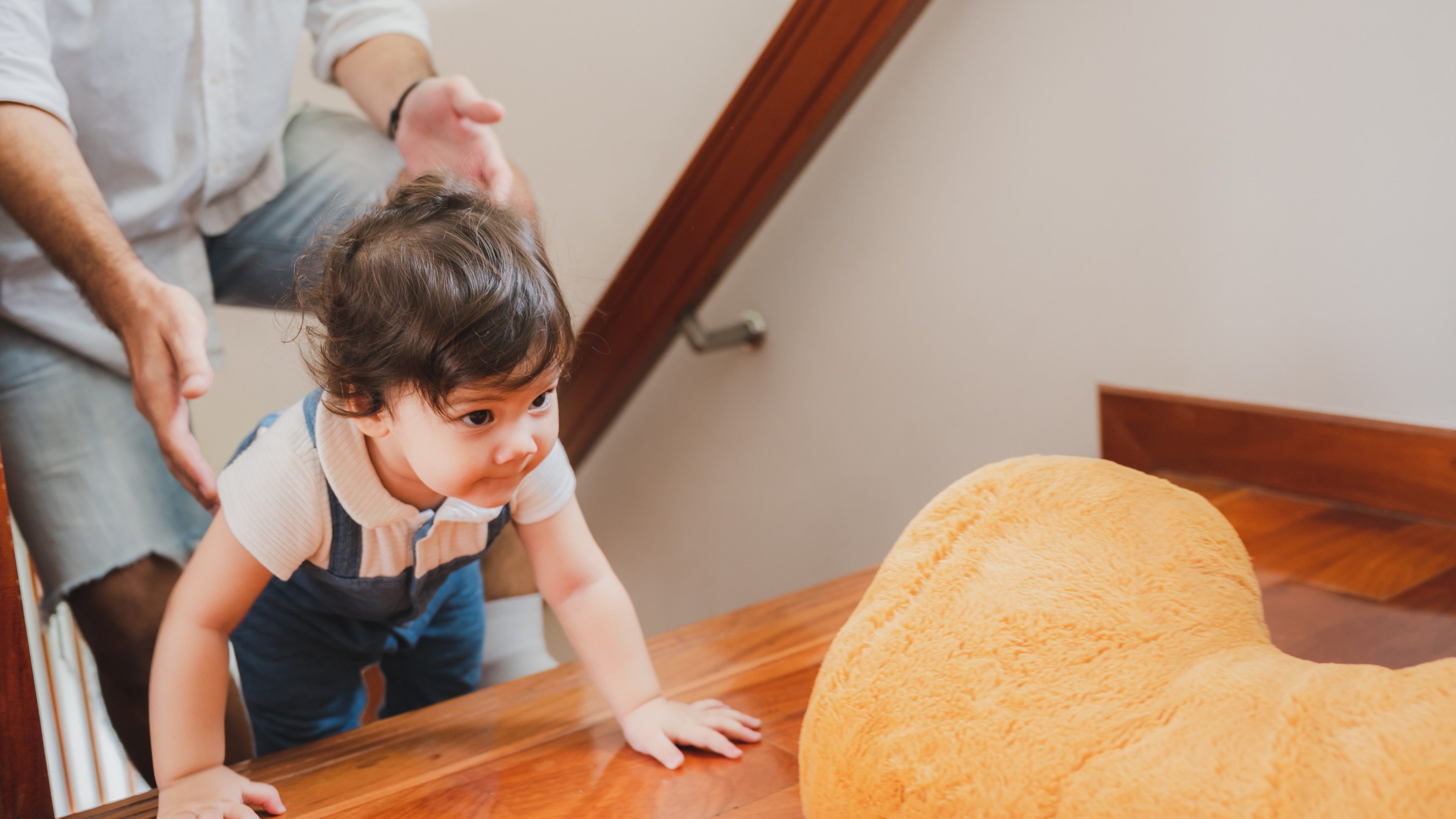 little toddler children with first walk step with stairs at home, small baby person are happy to play and learn to crawling with family, cute infant boy having fun and childhood care