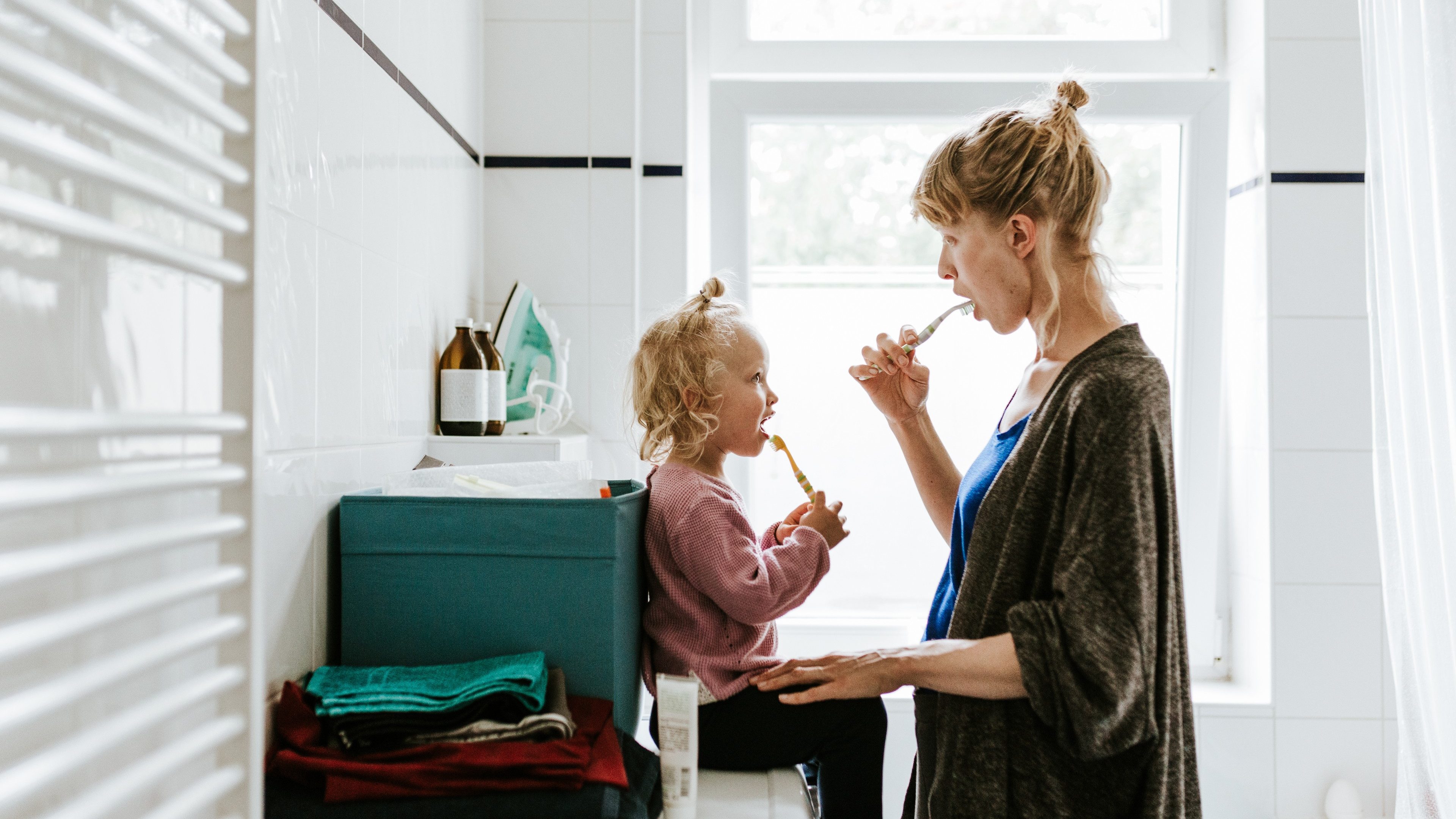 Photo series of a young mother with a child doing different chores at home. Shot in Berlin.