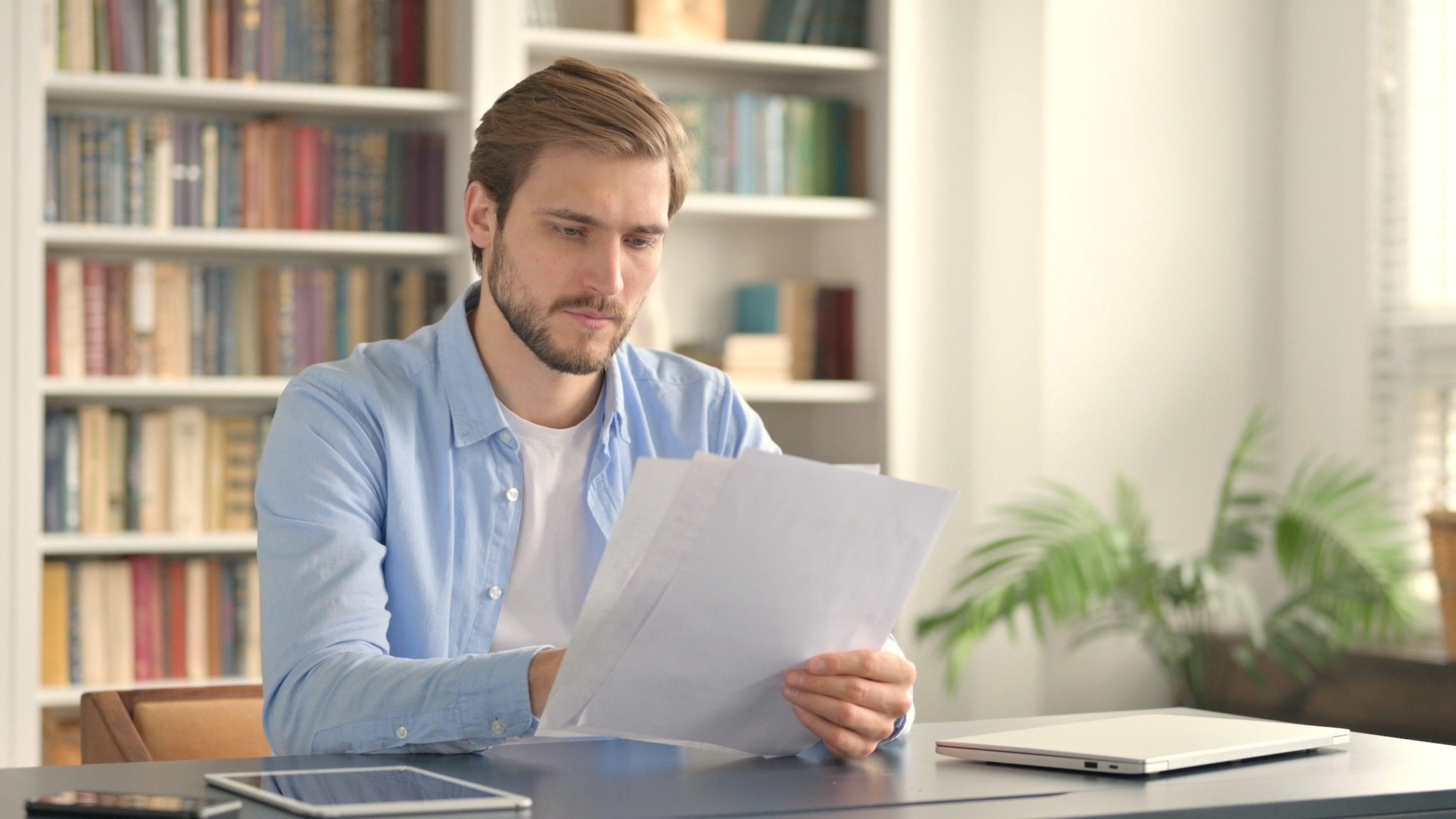 Man Reading Documents in Office