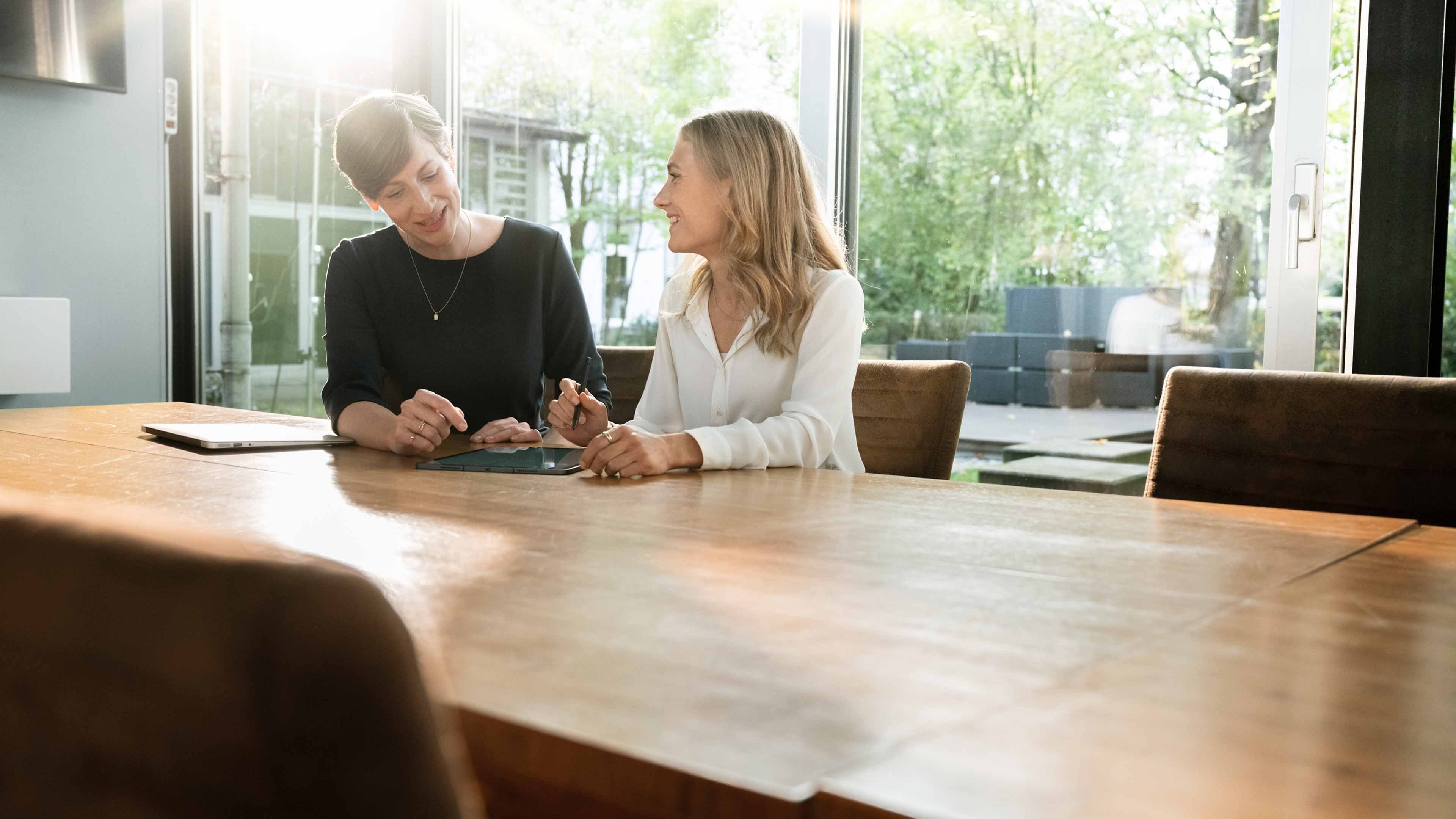 Female insurance mortgage broker agent consult young couple showing online presentation on laptop in office cafe, insurer financial advisor make business offer to interested clients look at computer