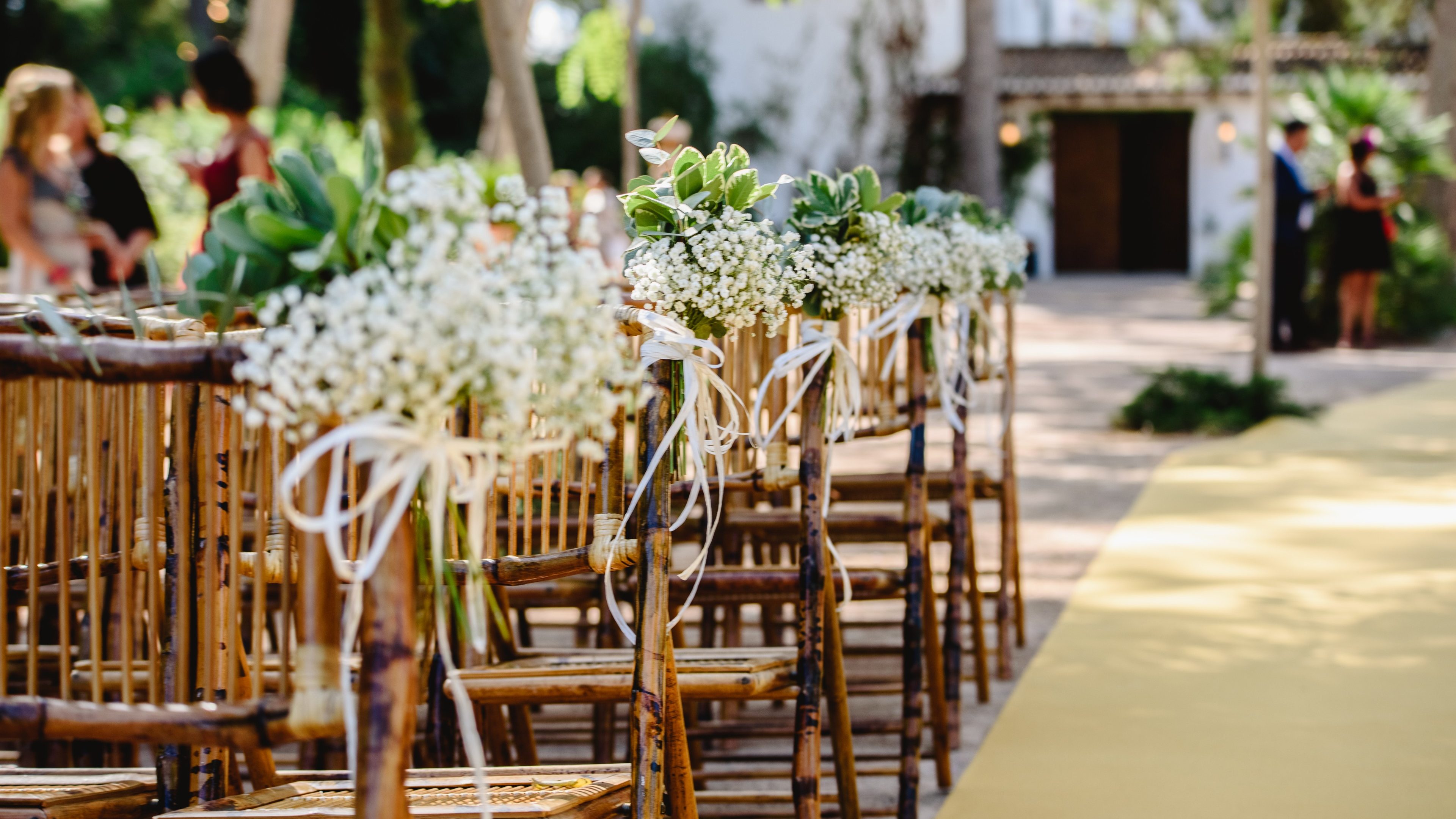 Floral arrangements for empty chairs for a wedding ceremony in spring