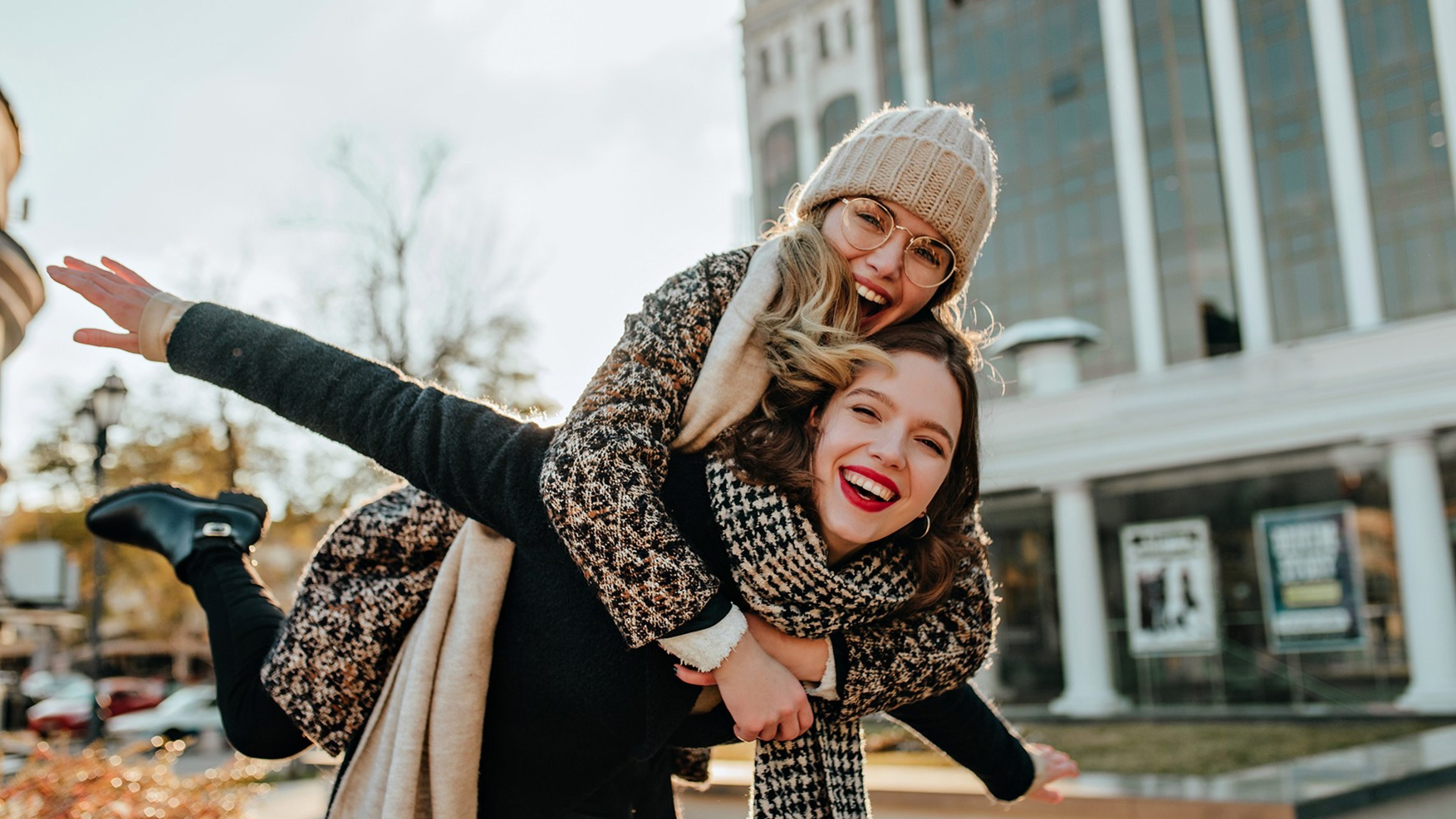 Inspired girls chilling in good autumn day. Outdoor photo of best friends laughing to camera