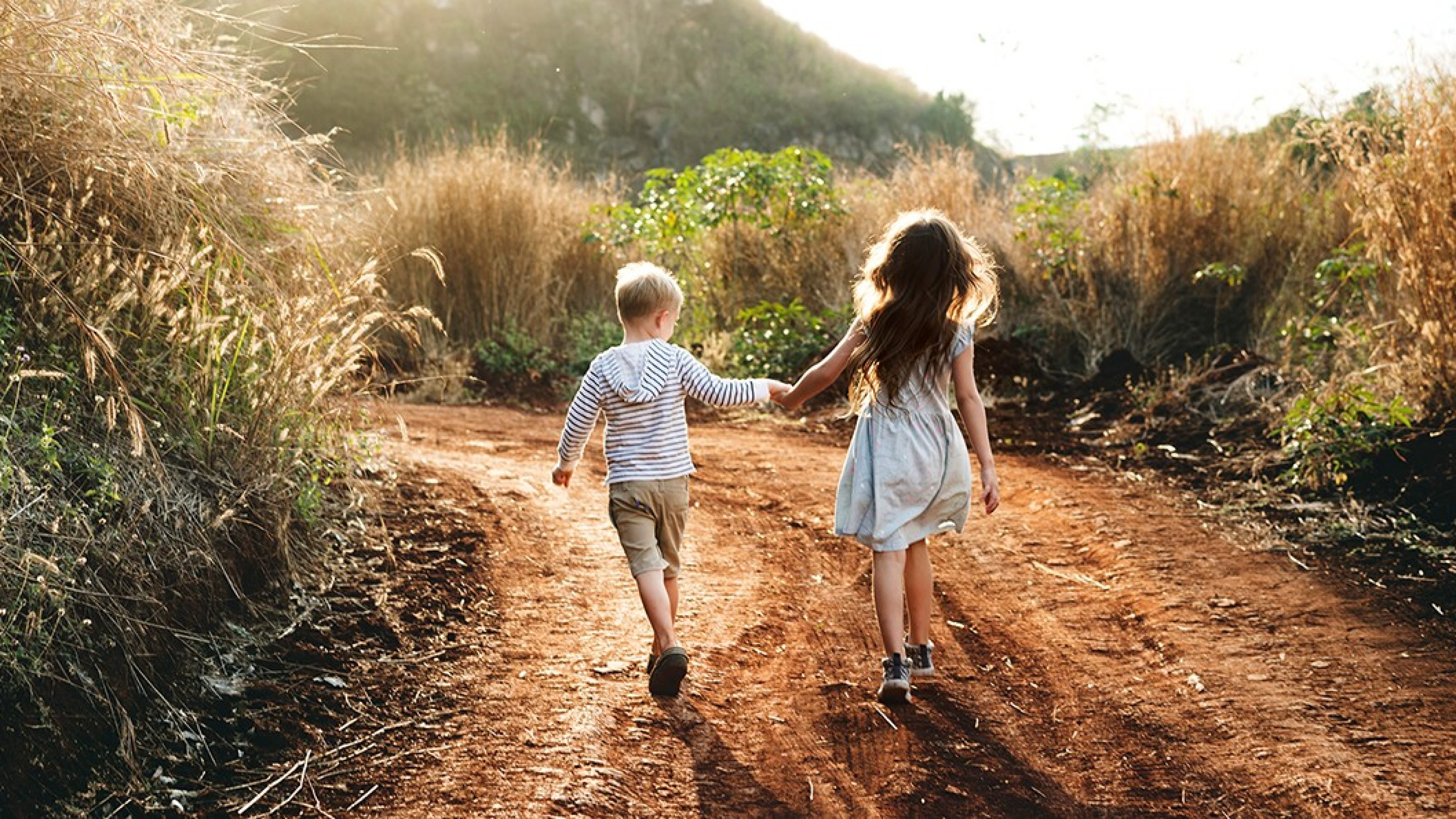 Brother and sister holding hands