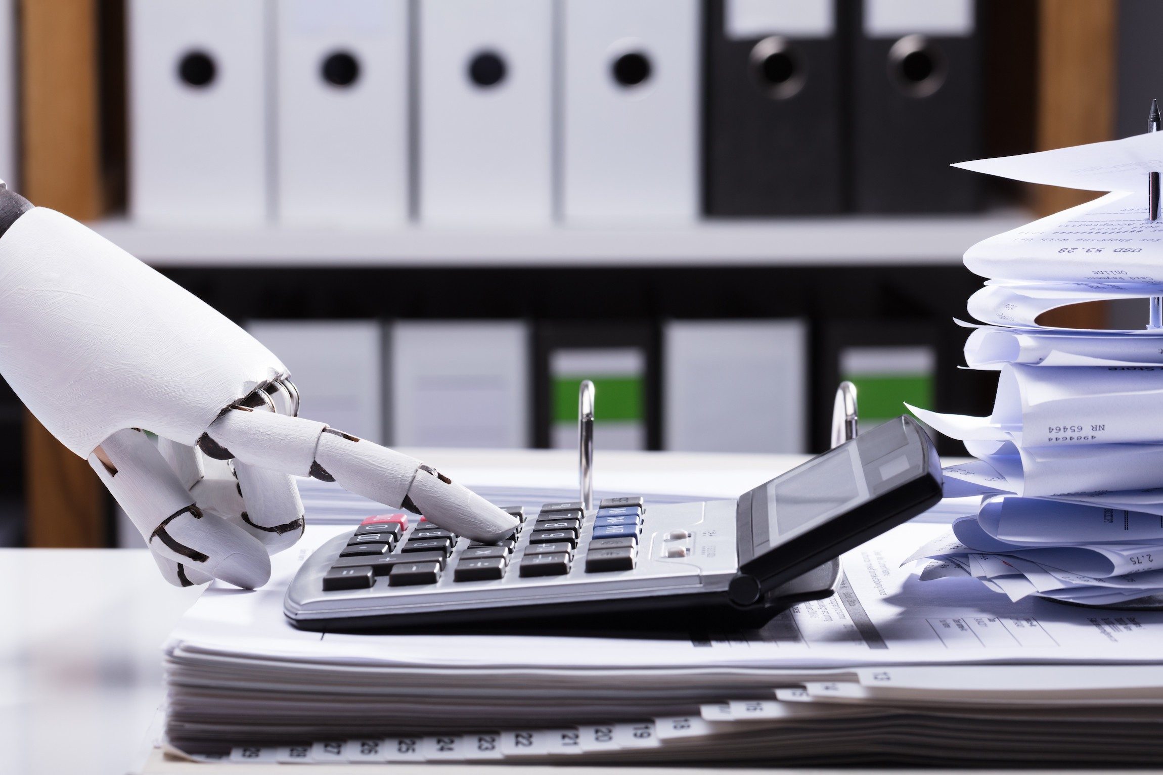 Close-up Of A Robotic Hand Using Calculator