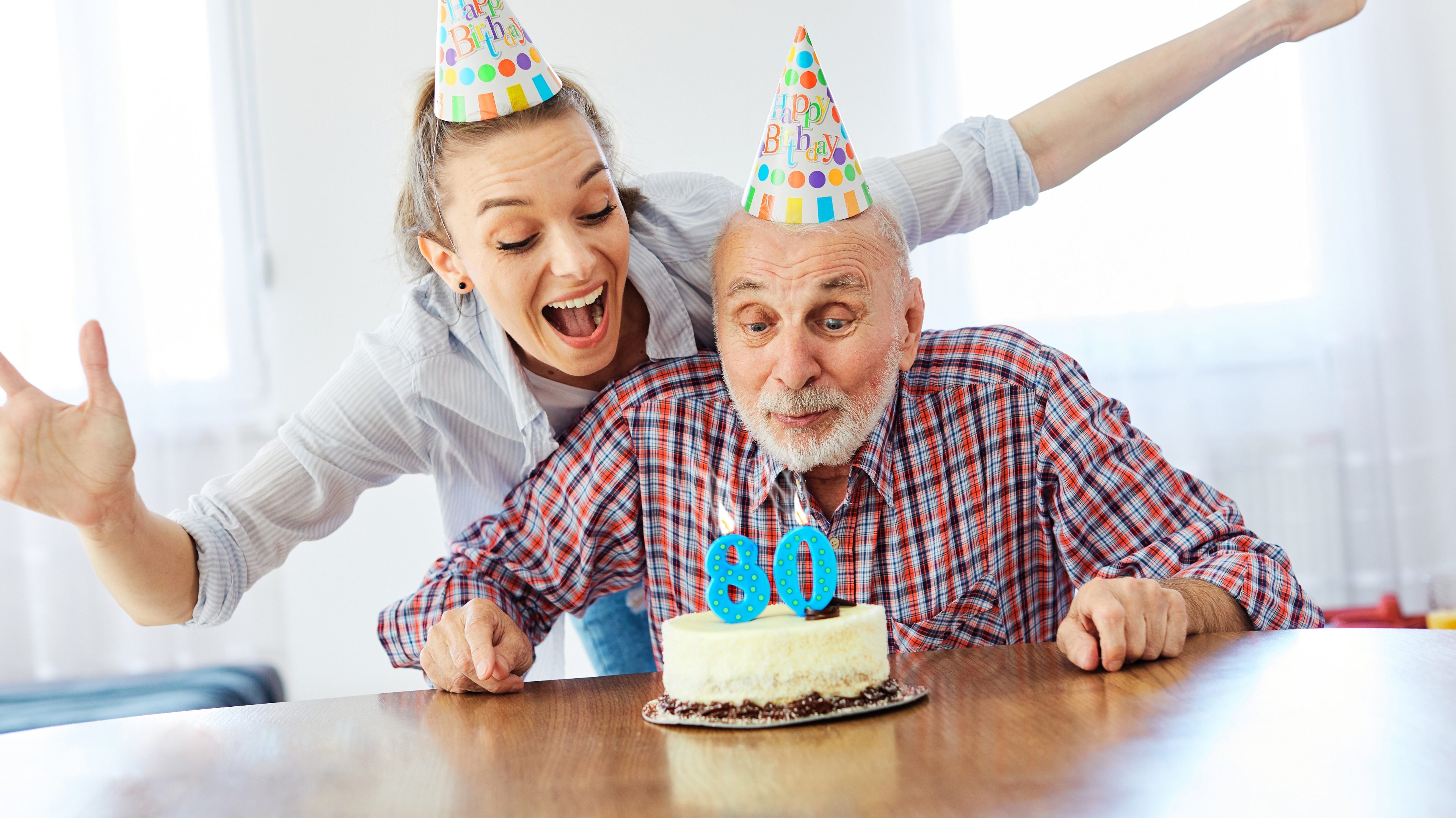Senior man and his daughter celebrating his 80th birthday at home