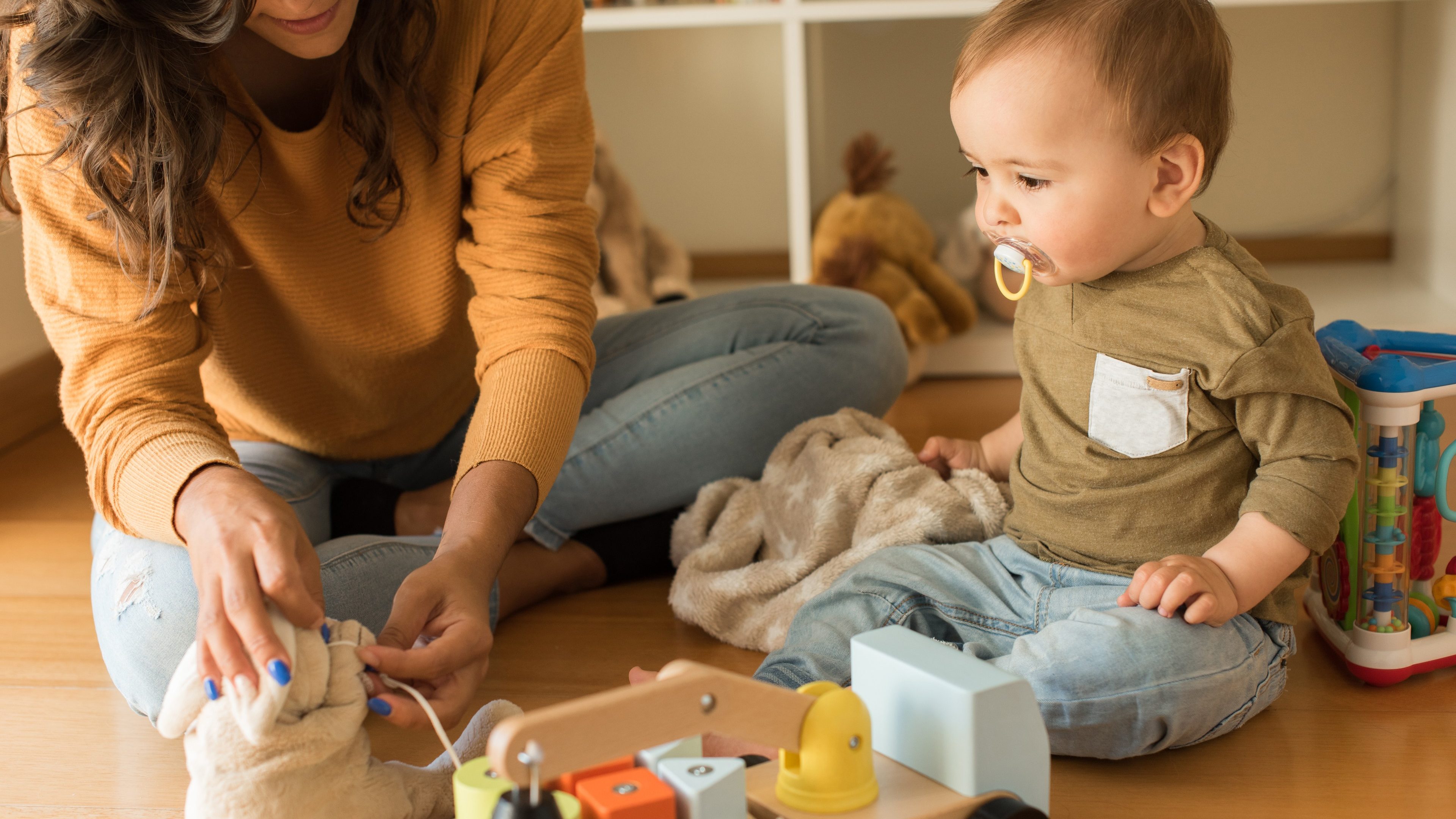 Young Mother playing with toddler at home 